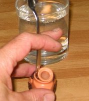Lever upwards around the cone to remove it