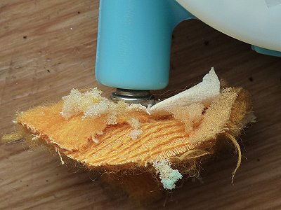 Voicebox exit hole with fabric attached to pop-rivet