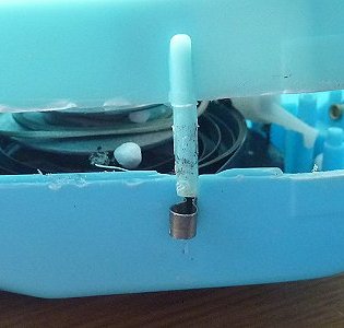 The top case pin that fits into the external spring loop