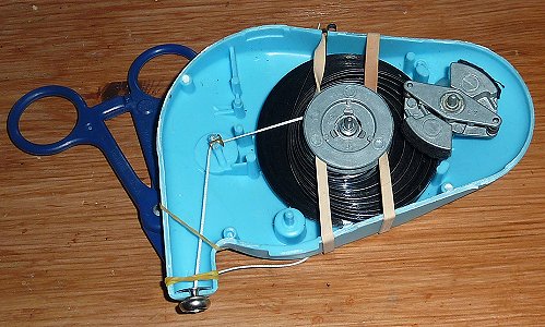 Rubber band holds the locking plastic forceps holding the cord