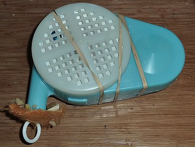 The rebuilt box held tightly by a rubber band